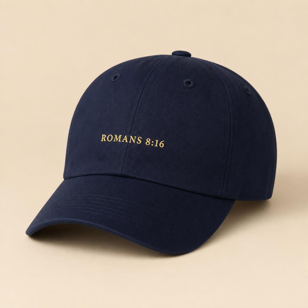 Navy baseball cap with gold embroidered Romans 8:16 text